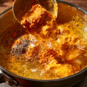 Making homemade turmeric golden paste by mixing turmeric, water, black pepper, and coconut oil