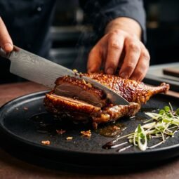 Slicing crispy roast duck skin